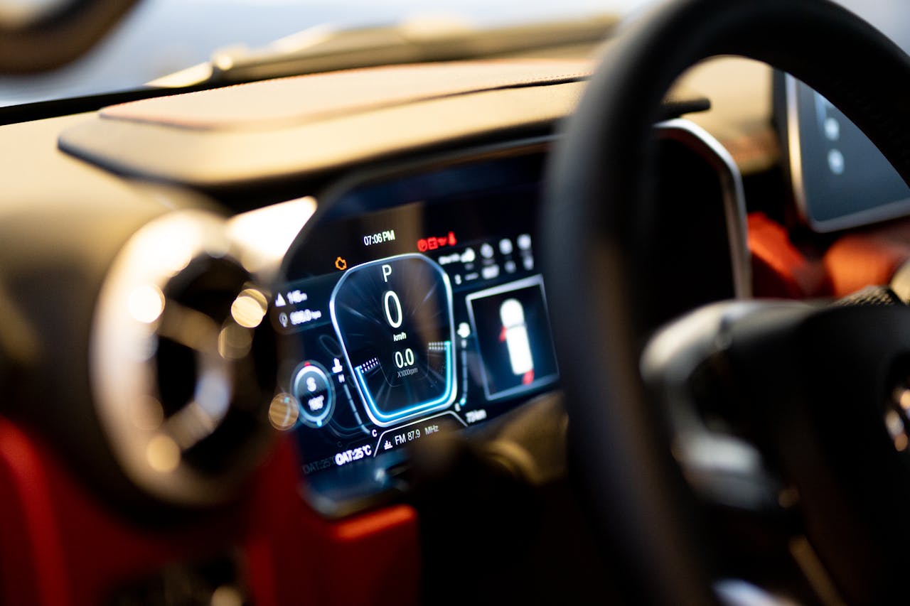 Close-up of illuminated car dashboard interior showing digital displays in Dubai showroom.